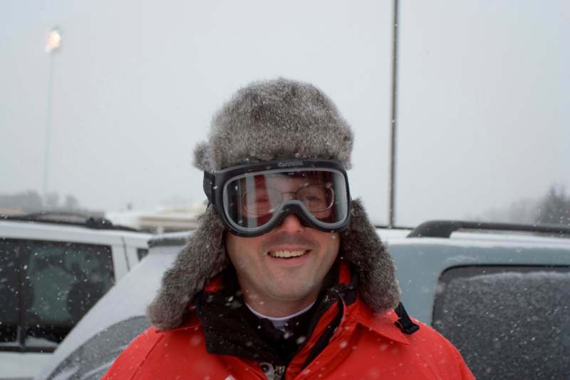 a man wearing goggles and a red jacket