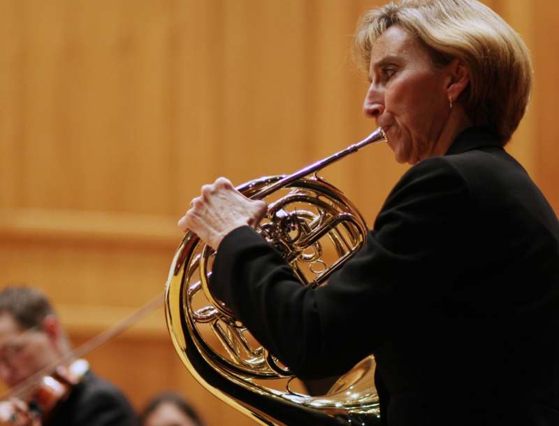 a woman playing a horn