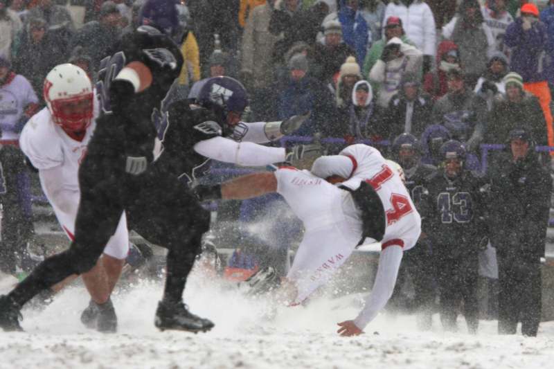 a football player falling into the snow