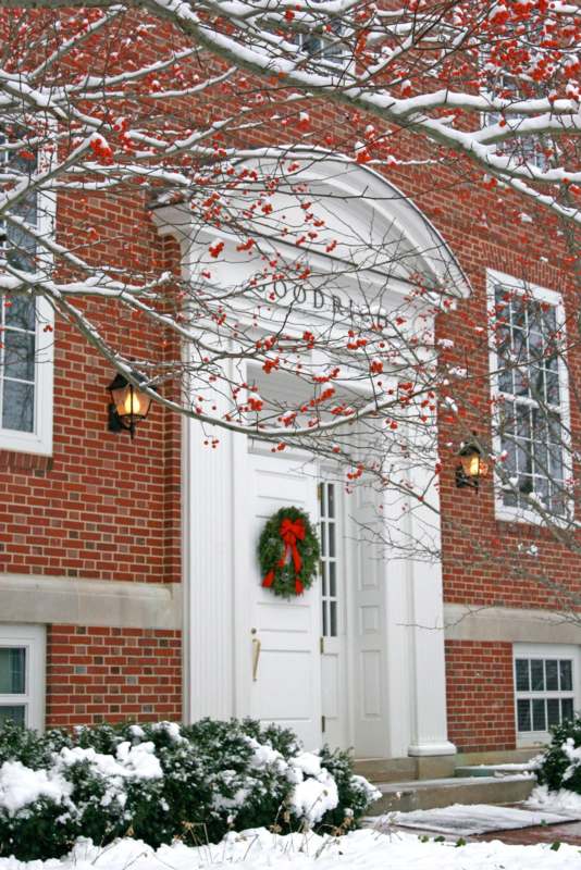 a brick building with a wreath on the front door