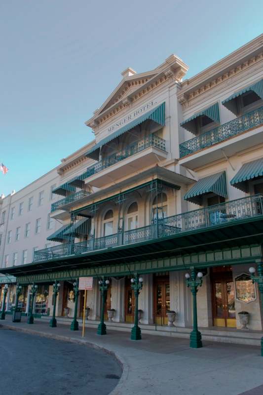 a building with green awnings and a blue sky