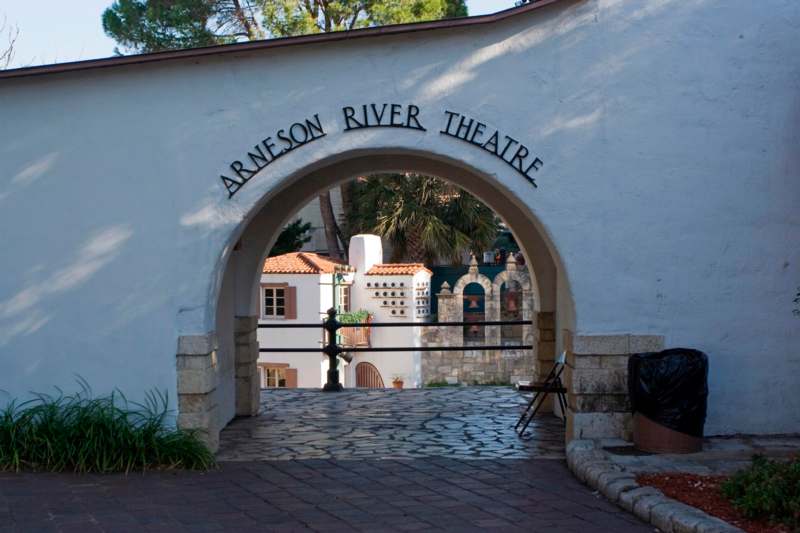 a white archway with a sign
