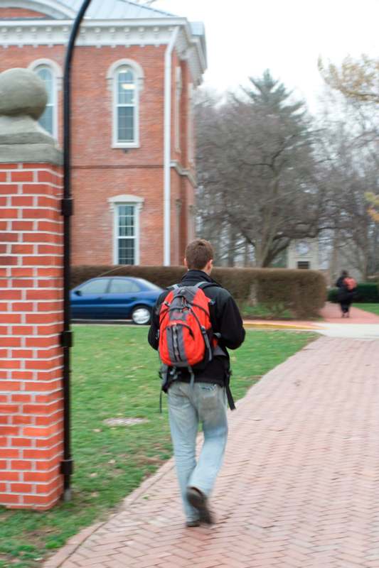 a man walking on a brick path