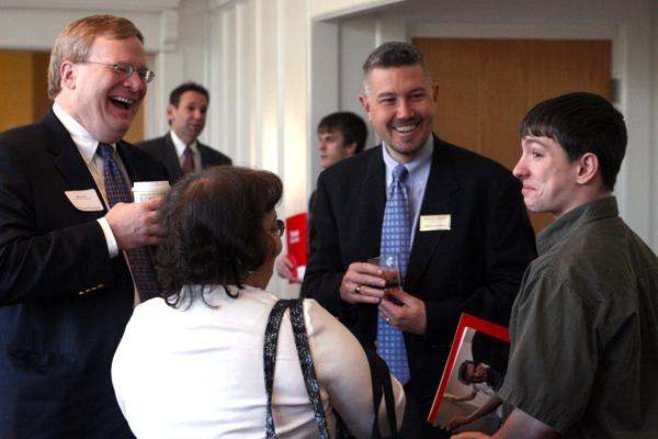 a group of people laughing at a business meeting