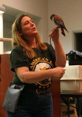 a woman holding a bird