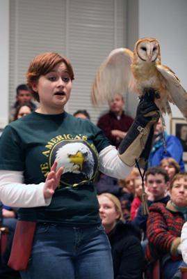 a woman holding an owl