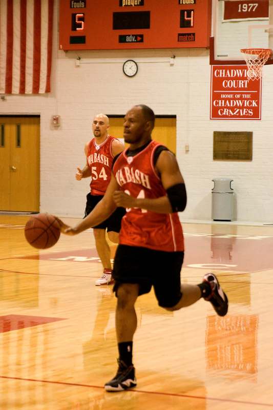 a basketball player dribbling a ball