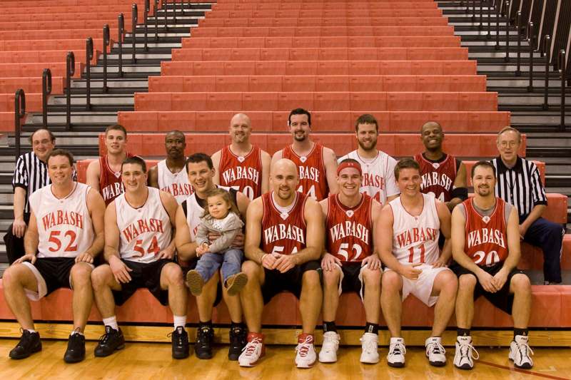 a group of basketball players posing for a photo