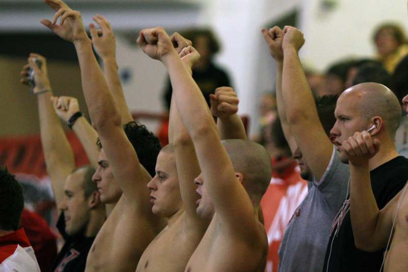 a group of men raising their hands