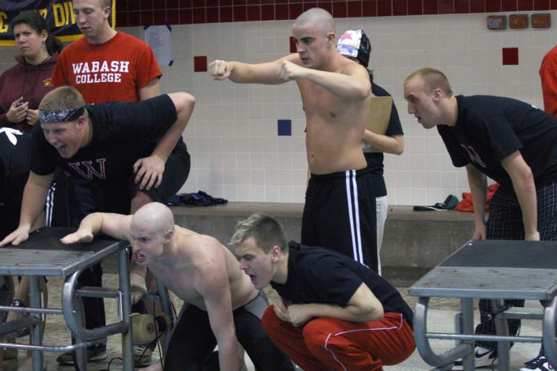a group of men fighting in a pool