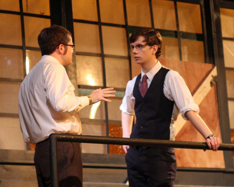 two men standing on a stage