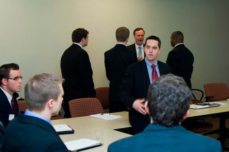 a group of men in suits in a meeting