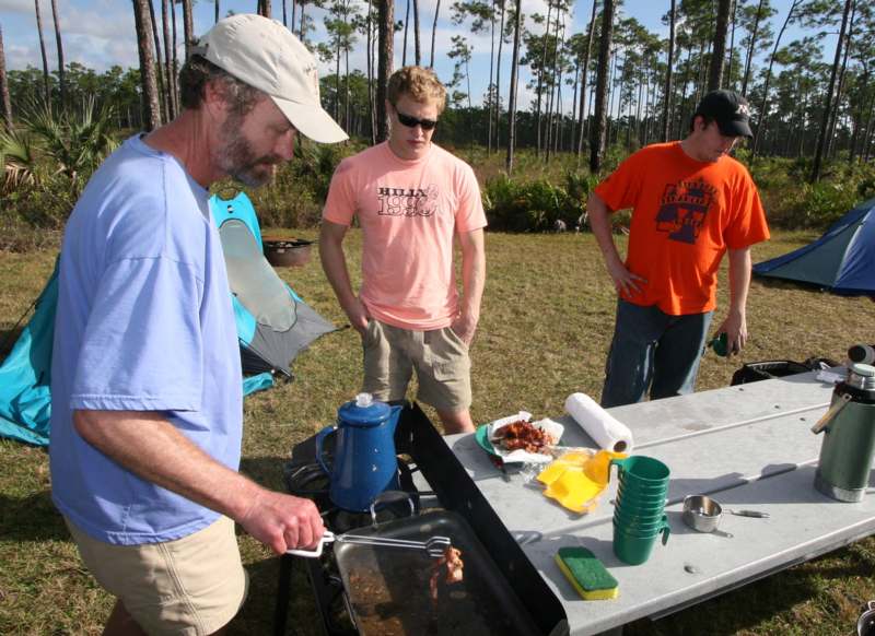 a group of men cooking food outside