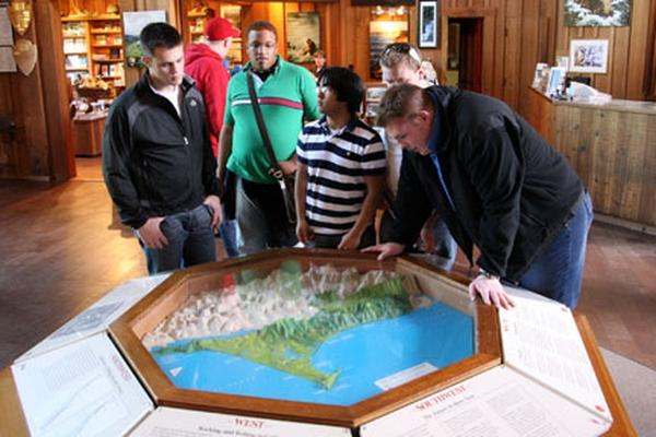a group of people looking at a map