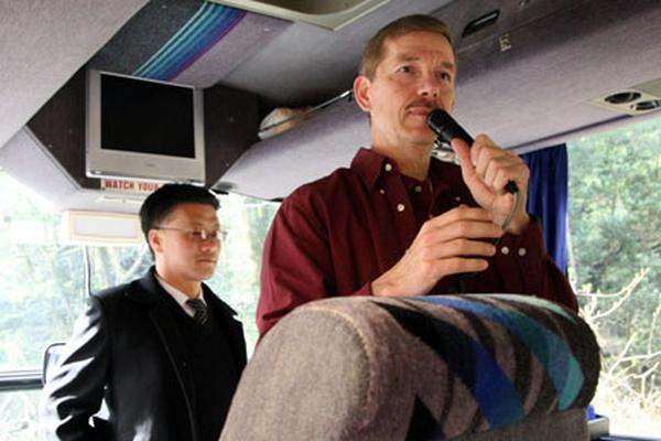 a man holding a microphone in a bus