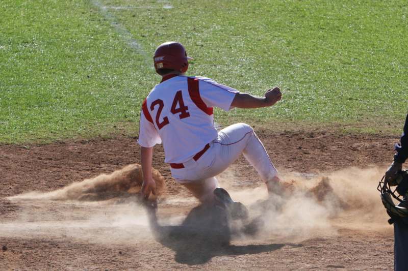 a baseball player sliding into a base