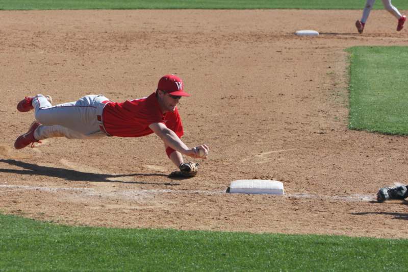 a baseball player sliding into base