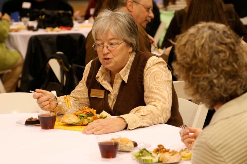 a woman eating at a table