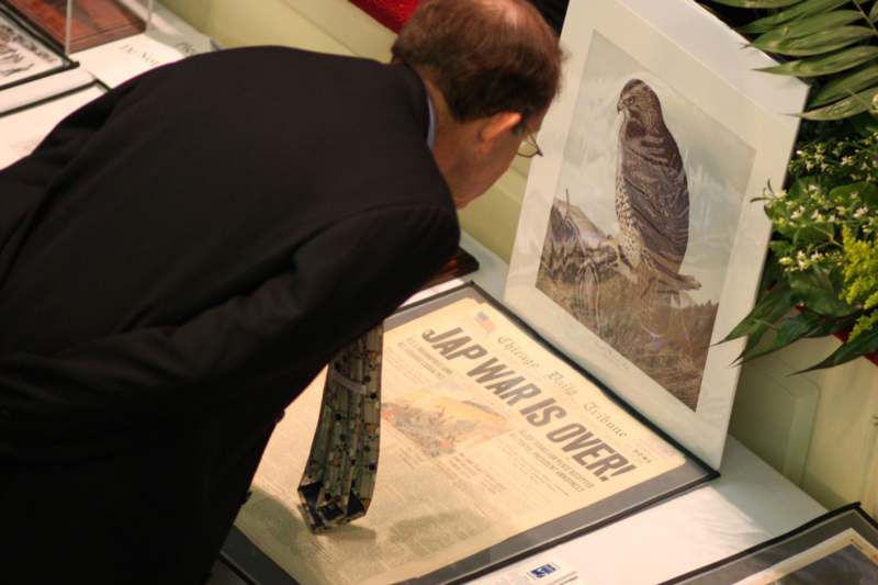 a man looking at a picture of a bird