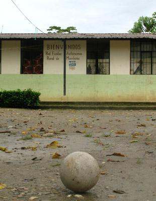 a ball on the ground in front of a building