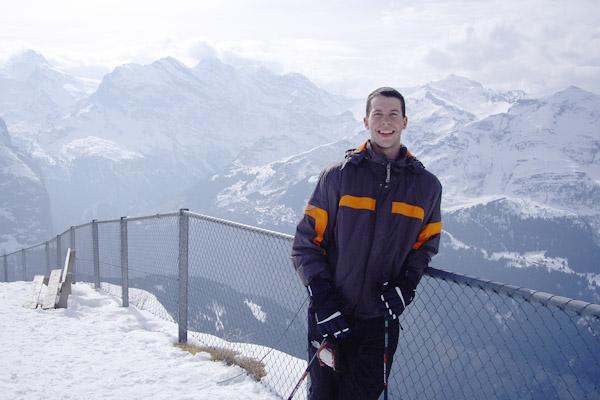 a man standing on a fence in the snow