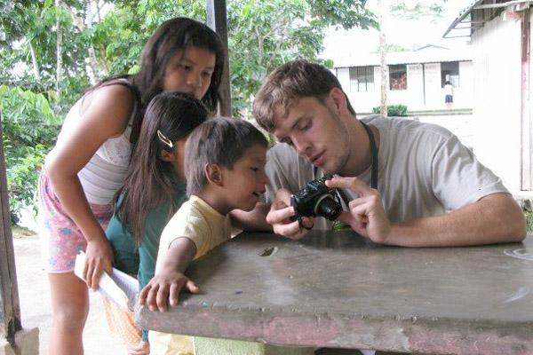 a man looking at a camera with a child