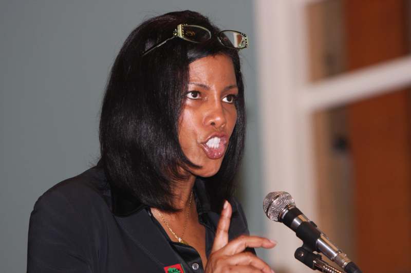 a woman sticking her tongue out while speaking into a microphone