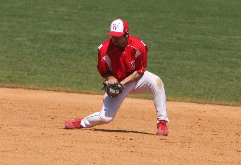a baseball player in red and white uniform