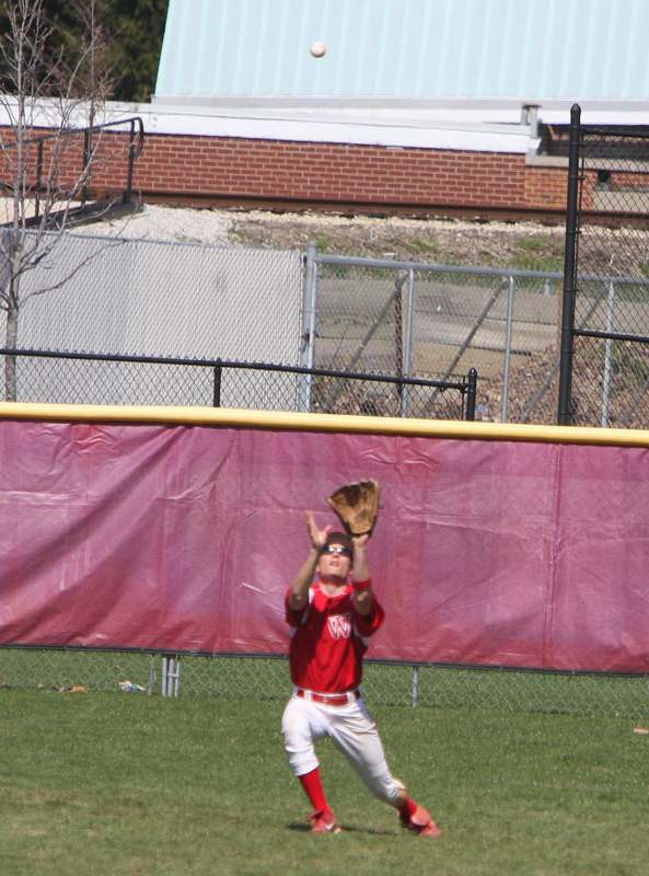 a boy catching a baseball