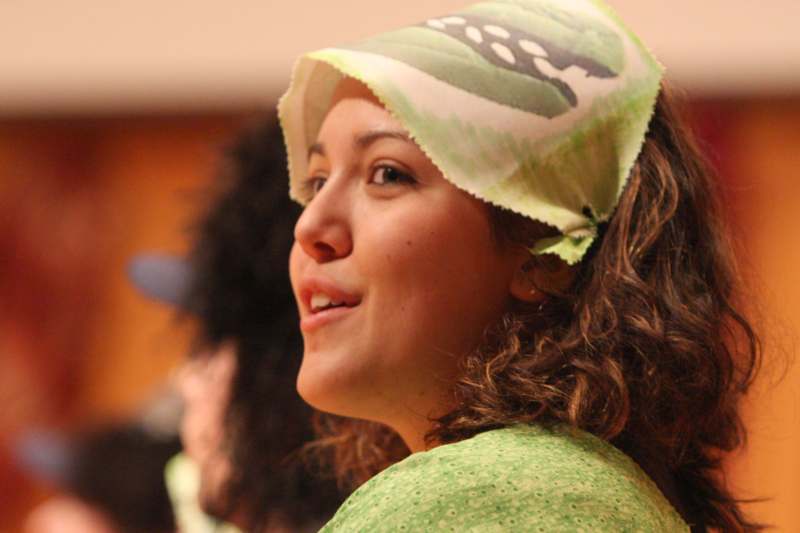 a woman wearing a green scarf on her head