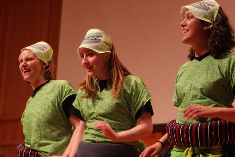 a group of young women wearing green t-shirts