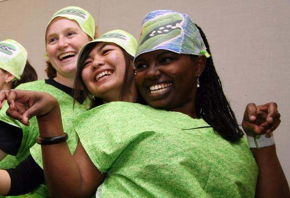 a group of women wearing green shirts and hats