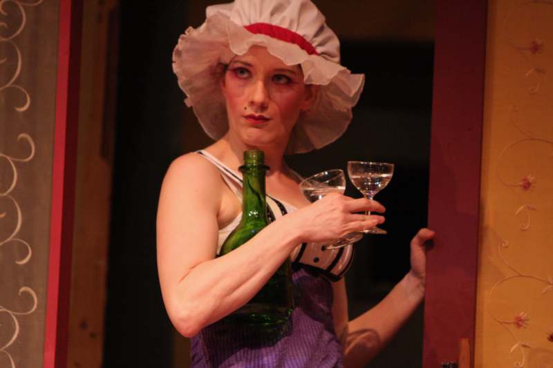 a woman in a garment holding wine glasses