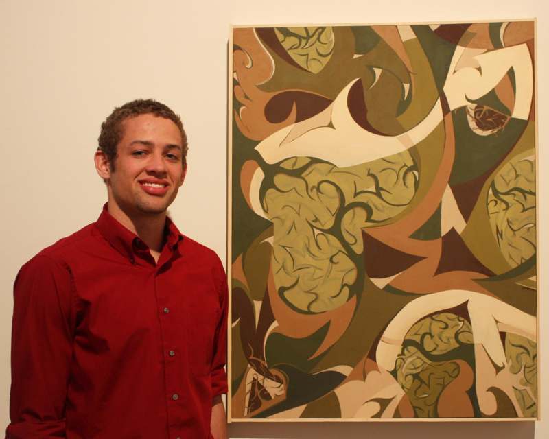 a man standing next to a painting