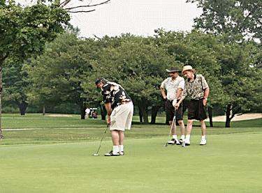 a group of men playing golf