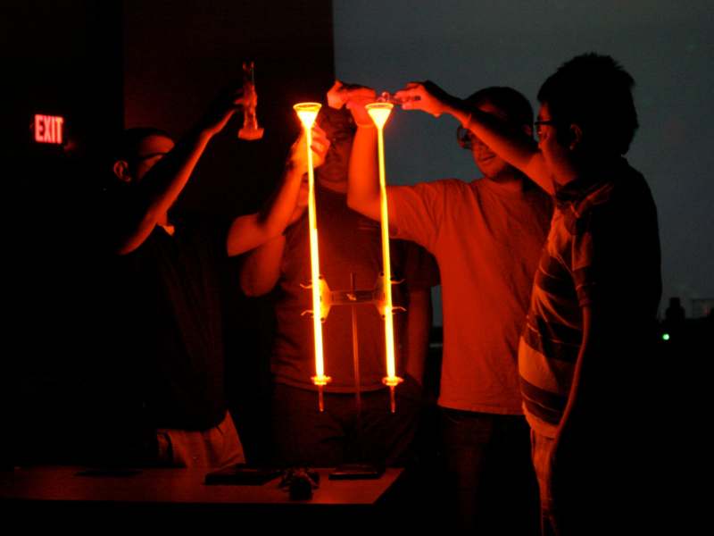 a group of people holding up a light