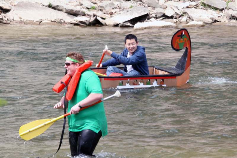 a man in a boat with a man in a green shirt