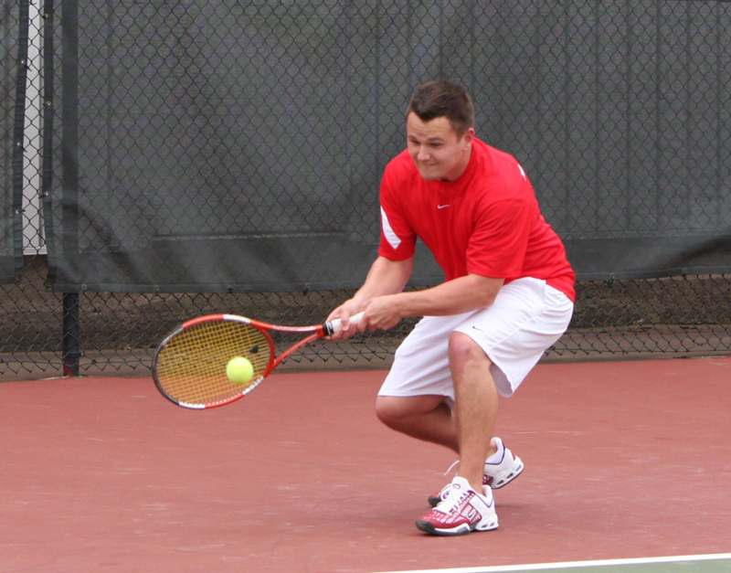 a man playing tennis on a court