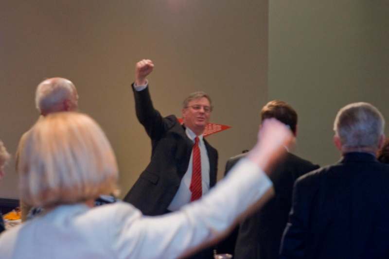 a man in a suit raising his fist