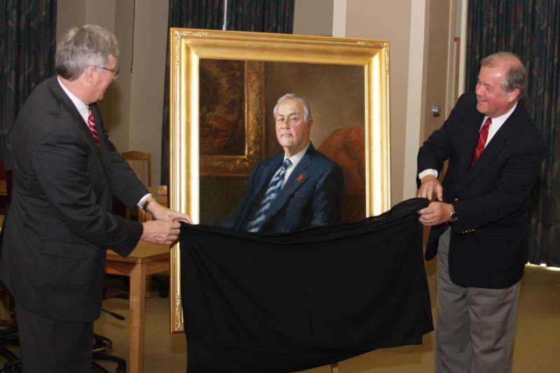 men holding a piece of art