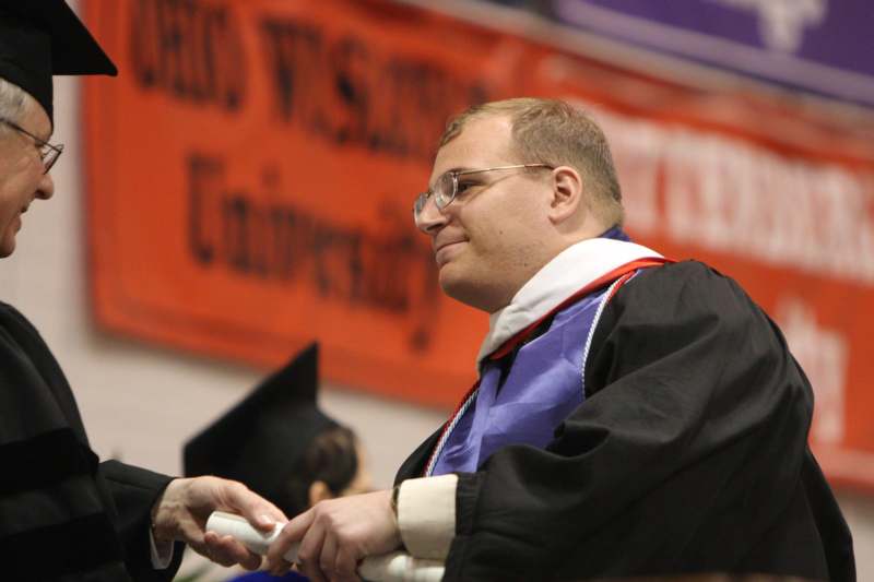a man wearing a graduation gown