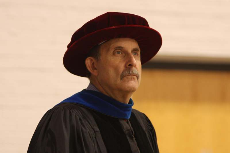 a man wearing a robe and a hat