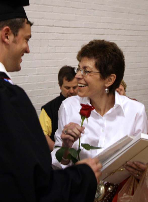 a man holding a rose and smiling woman