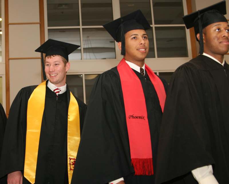 a group of men wearing graduation gowns and caps