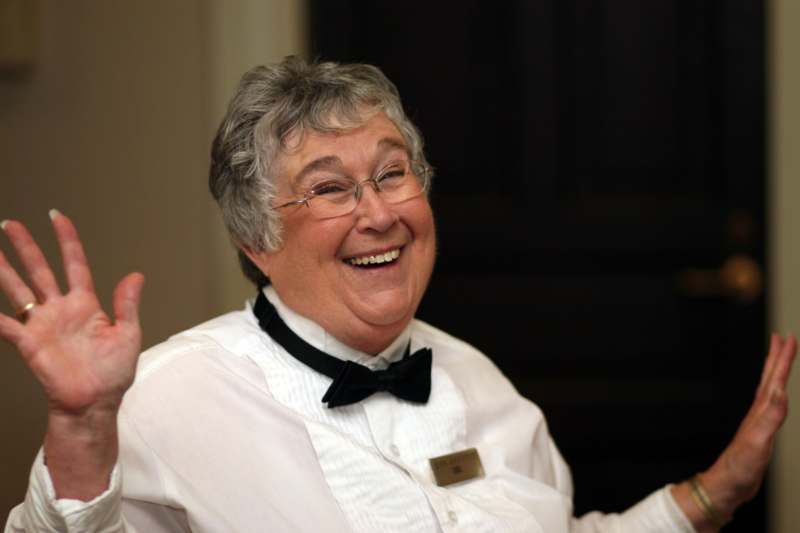 a woman wearing glasses and a bow tie
