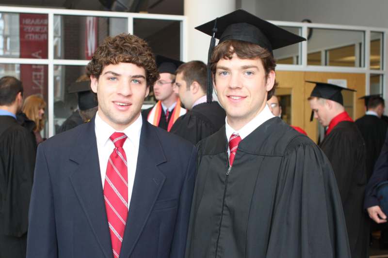 a couple of men in graduation gowns
