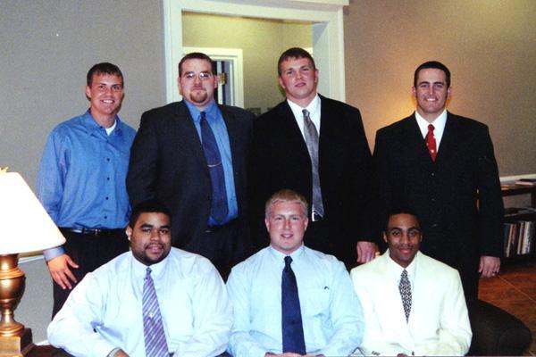 a group of men posing for a photo
