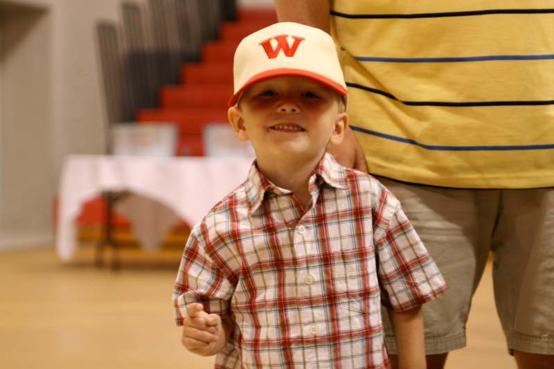 a boy wearing a hat and smiling