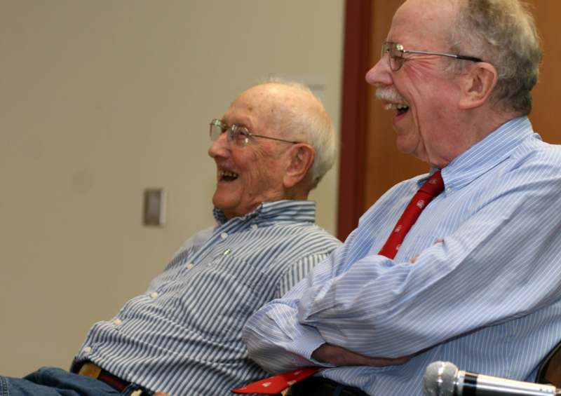 a pair of older men laughing