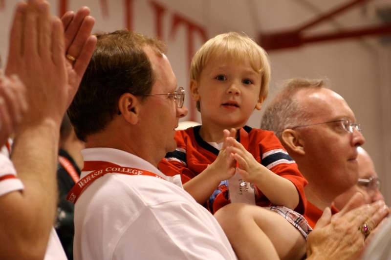 a man and a child clapping